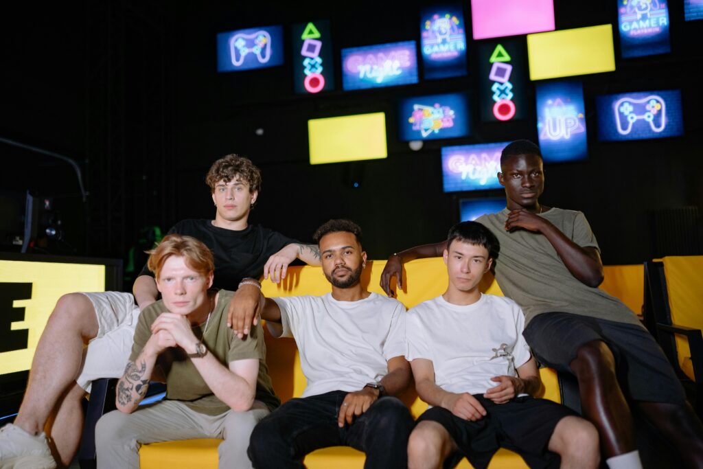 A diverse group of young men sitting together at a gaming event, showcasing friendship and togetherness.
