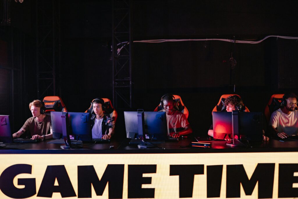 A group of diverse gamers participating in an online eSports tournament indoors.
